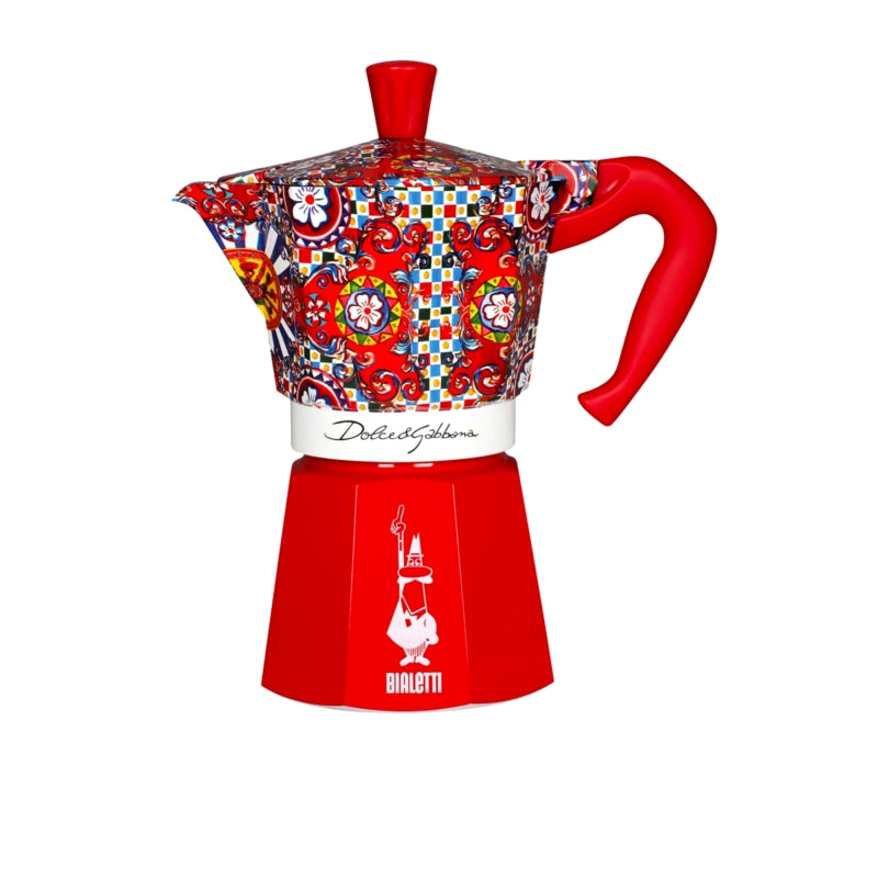 Decorative coffee maker with colorful patterned top and red base on a white background